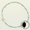Sterling silver flat cable satellite chain bracelet with turquoise enamel bead.